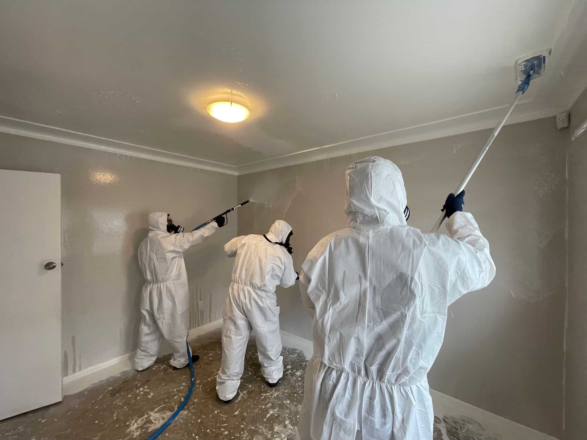 iDry technician in full PPE performing meth decontamination surface treatment in an Auckland property